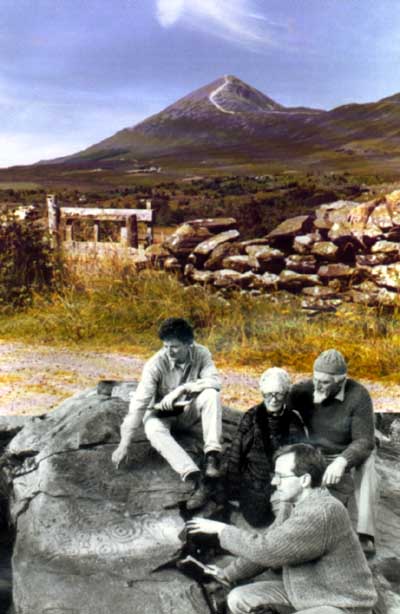 Archaeologists Jerry Walsh and Kieran Irwin indicating the newly exposed panel of Bronze Age carving to Mary and Don Gibbons on whose land the rock is situated.