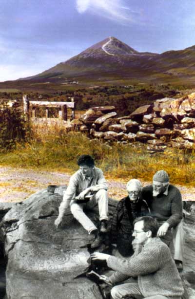 Archaeologists Jerry Walsh and Kieran Irwin indicating the newly exposed panel of Bronze Age carving to Mary and Don Gibbons on whose land the rock is situated.