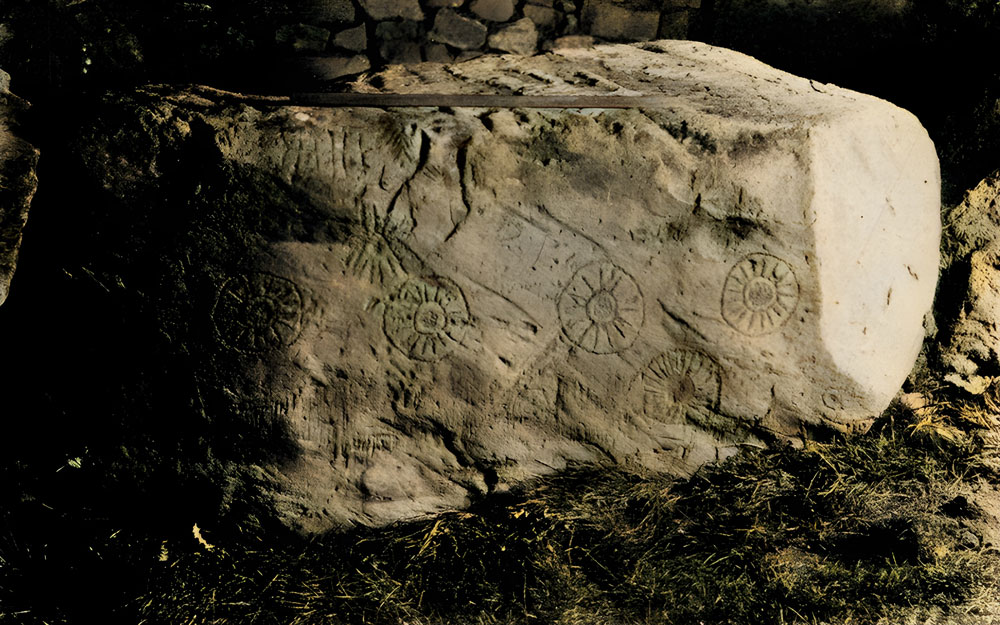 The first modern photograph of the Stone of the Seven Suns taken by Thomas Mason in the early 1935's, not long after the stone had been exposed from material fallen from the cairn after the 1847 excavations.