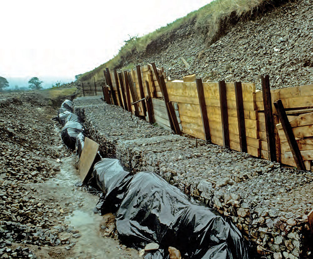 The back of Newgrange showing the repairs undertaken after the major cairn collapse caused by a back-up of water caused by the reinforced concrete additions to the front of the monument. The image is taken Newgrange revisited: new insights from excavations at the back of the mound in 1984–8 by Ann Lynch.