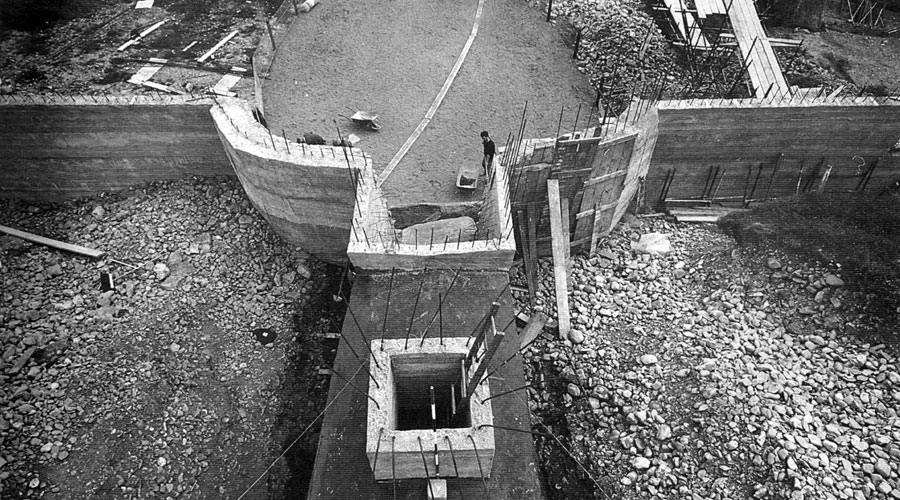 Newgrange during renovations: a concrete wall is erected to hold up the quartz wall.