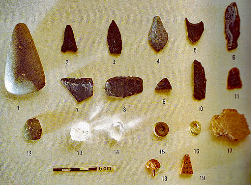 Finds from Poulnabrone: a stone axe, flints and arrowheads, and two pieces of clear quartz crystal.