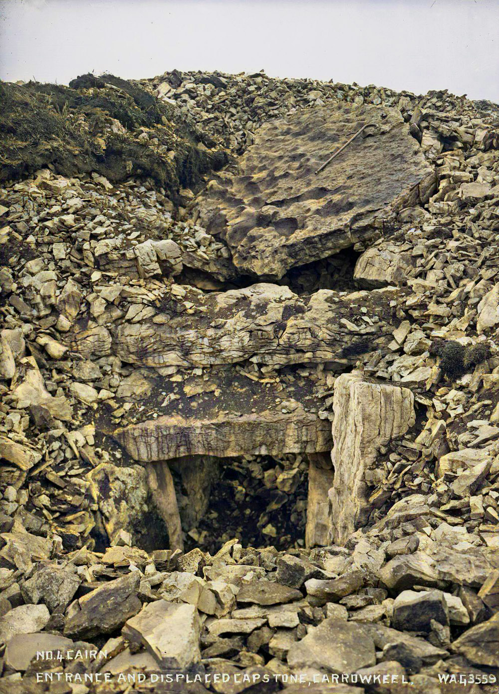 Entrance to Cairn F before the capstone was smashed and the chamber cleared, 1911.