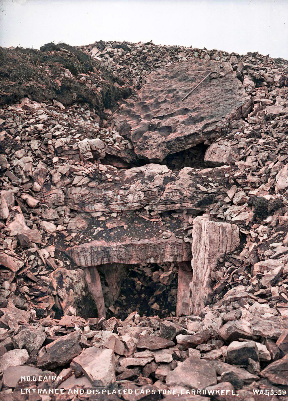 Ruined doorway of Cairn F in 1911.