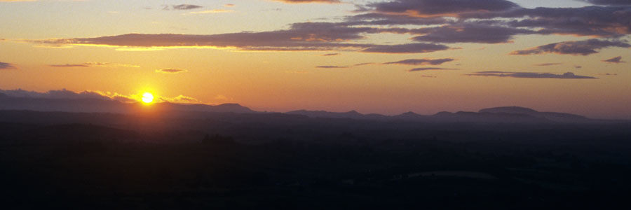 A
      sunset near the summer solstice viewed from Cairn G.