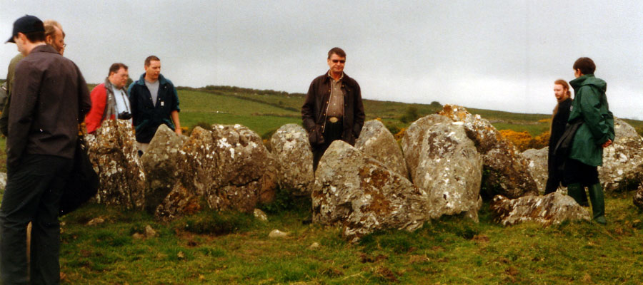 Goran Burenhult (centre), the chief excavator leads a tour at Circle 27, Carrowmore
    during the Stones and Bones conference in 2002.