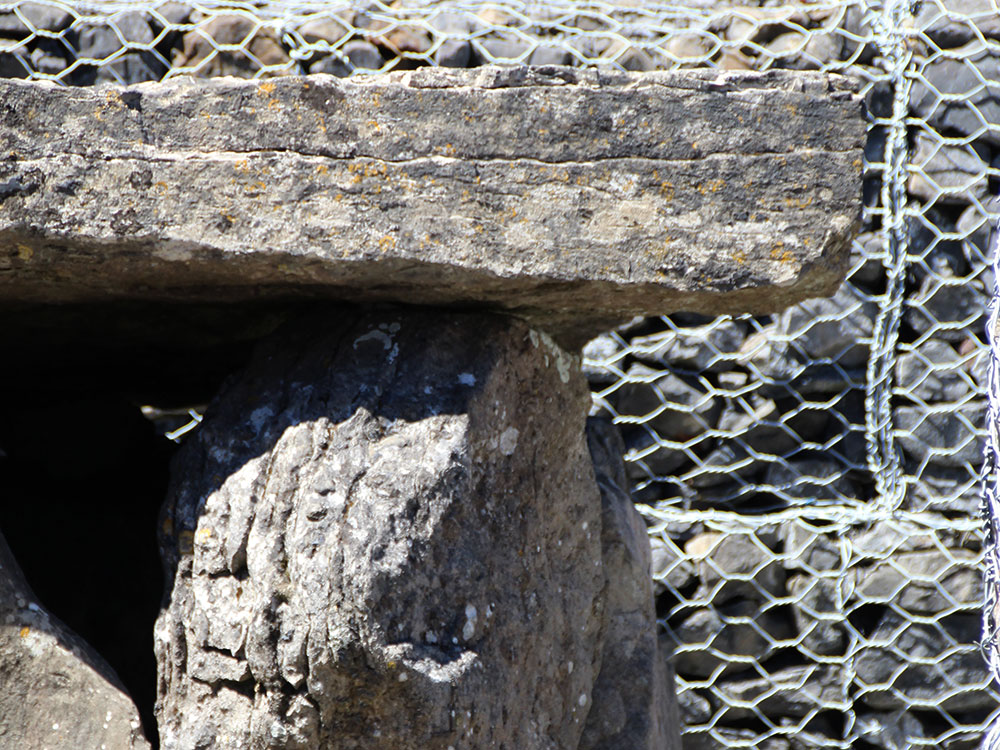 Carved neolithic art on the edge of the capstone at Listoghil.