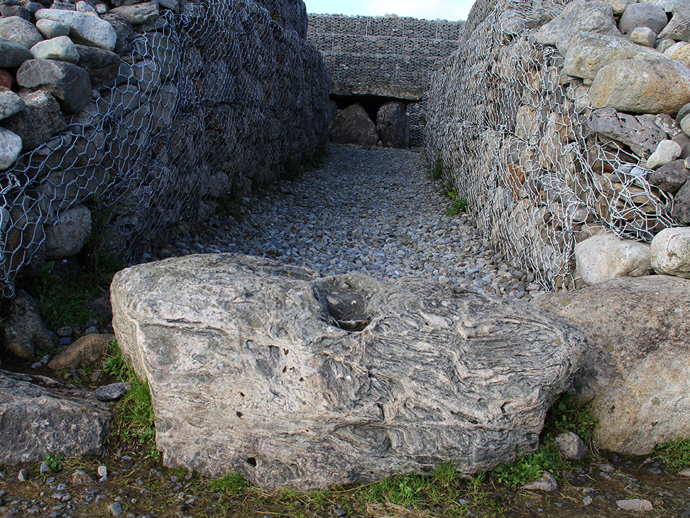The kerbstone known as the 'footprint stone' marks the entrance to Listoghil.