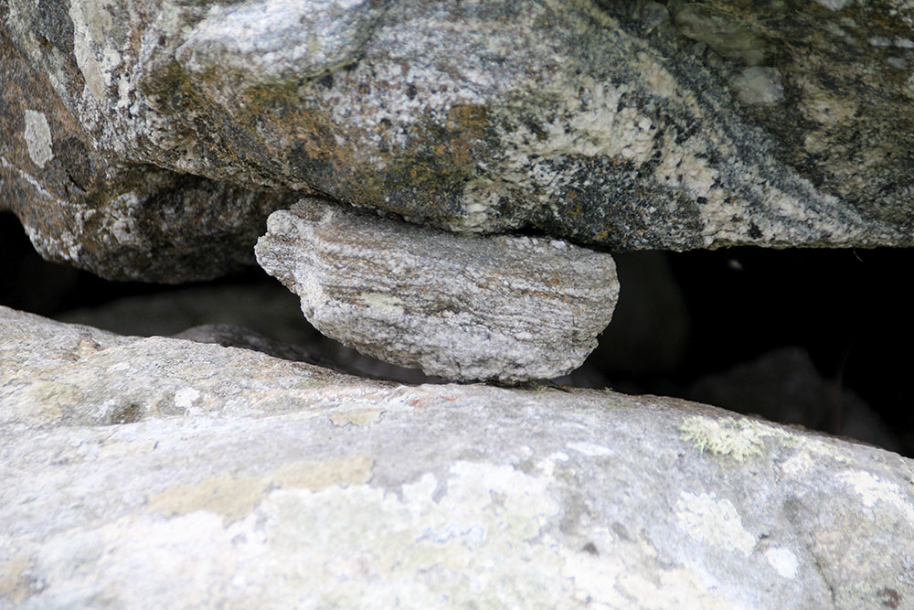 A small spall stone under the capstone of Dolmen 54.