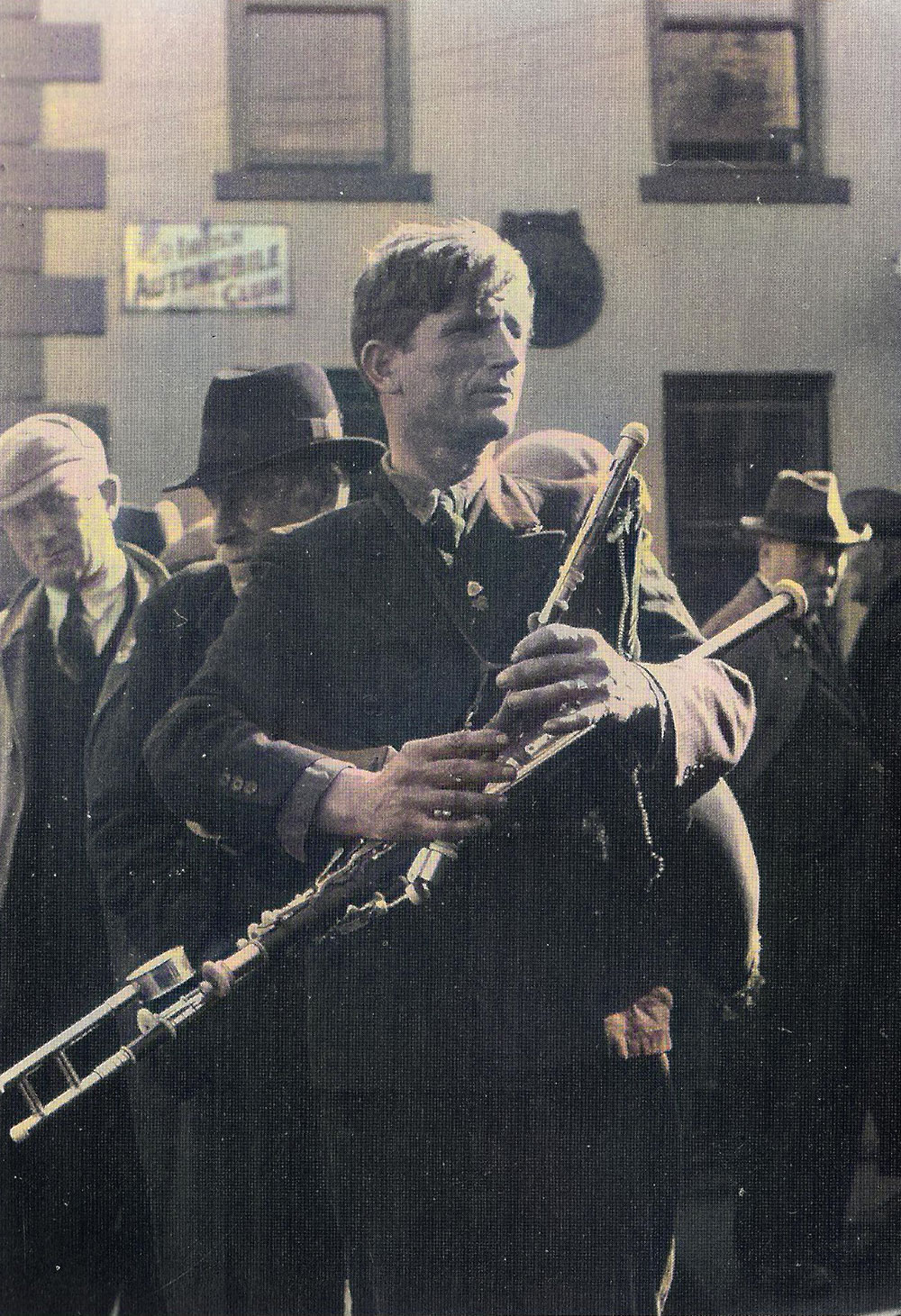 Master piper Johnny Dorna busking at the Lammas fair in Ballycastle around 1936.