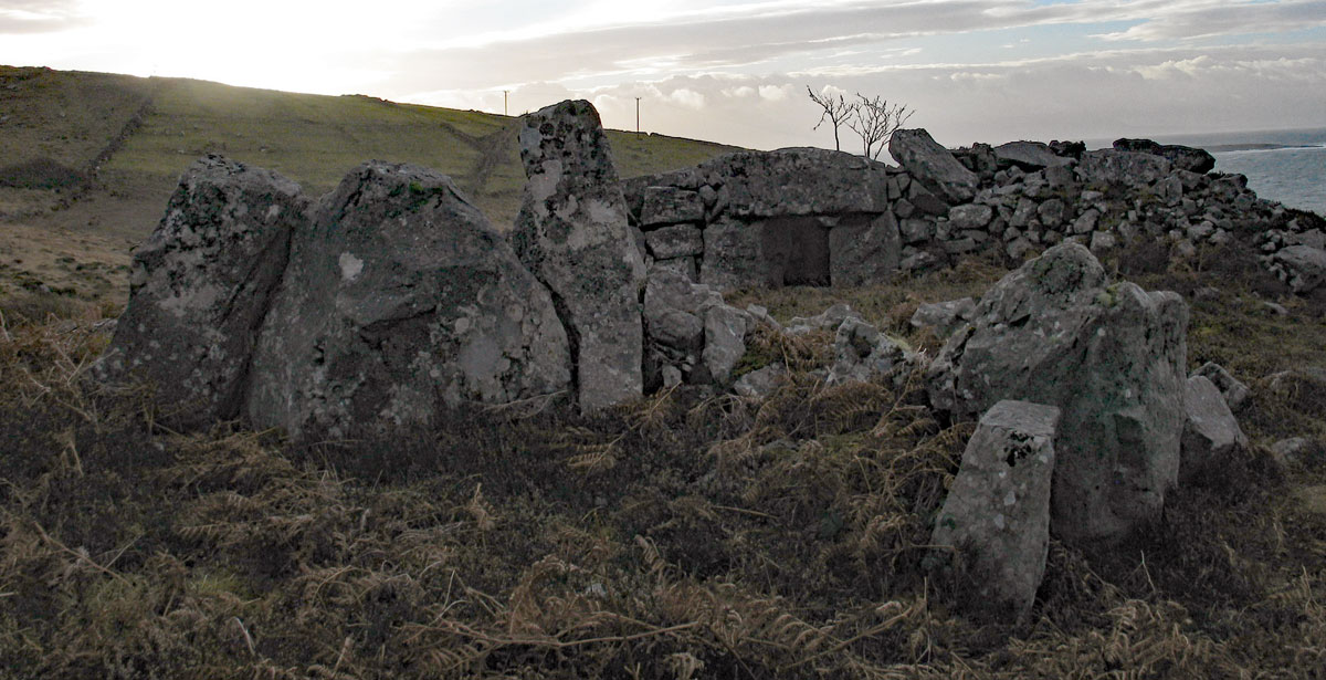 Looking south past the cist or external chamber built into the west arm of the court at Croaghbeg court tomb.