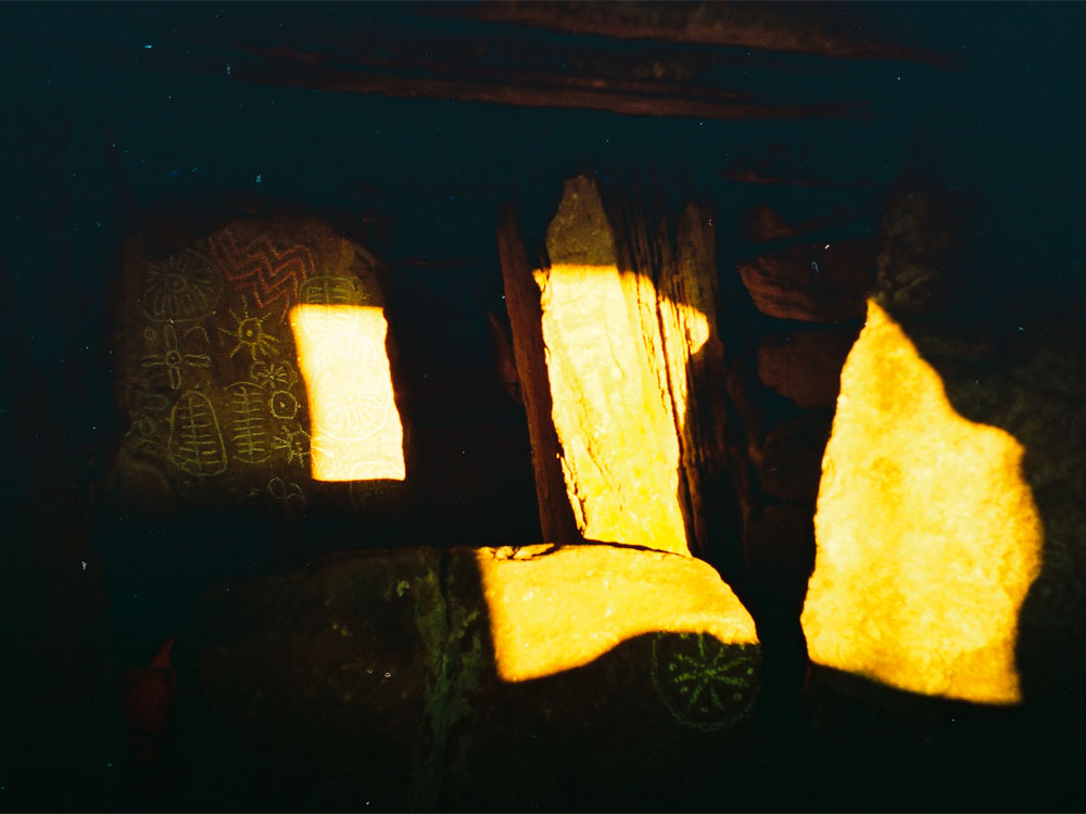 Equinox sunrise illuminates megalithic art within Cairn T, the Hag's Cairn at Loughcrew in County Meath.