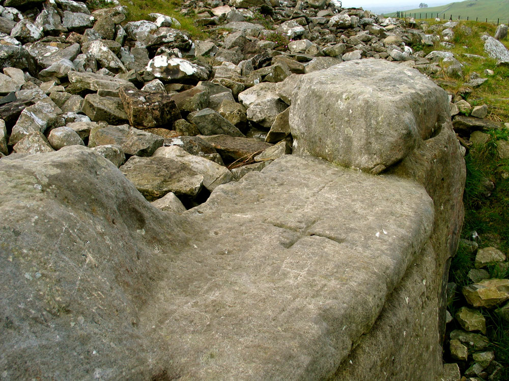 The cross cut into the seat of the Hag's Chair.