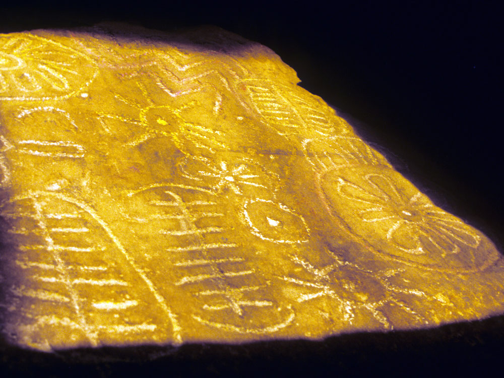 Equinox sunrise illuminates megalithic art within the chamber of Cairn T at Loughcrew.