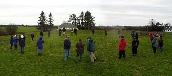 Professor John Waddell using very cold Archeology students to outline the 14 meter structure at Rathmore in Rathcroghan, 16th Feburary, 2002. A similar structure once stood on top of Queen Maeve's Palace.